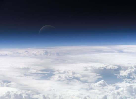 View looking down from Earth's atmosphere at clouds.