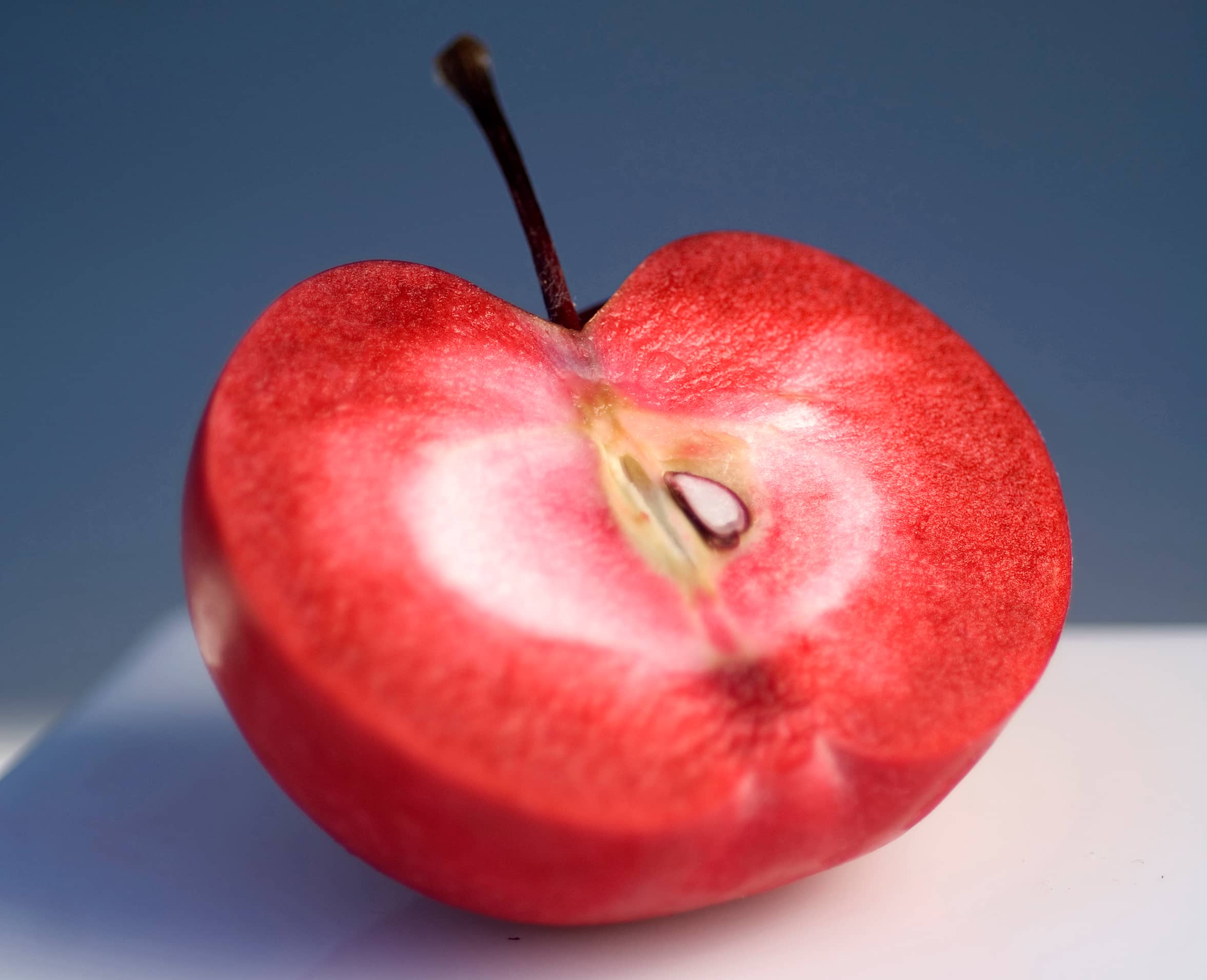 Halved new apple cultivar showing it's red flesh.