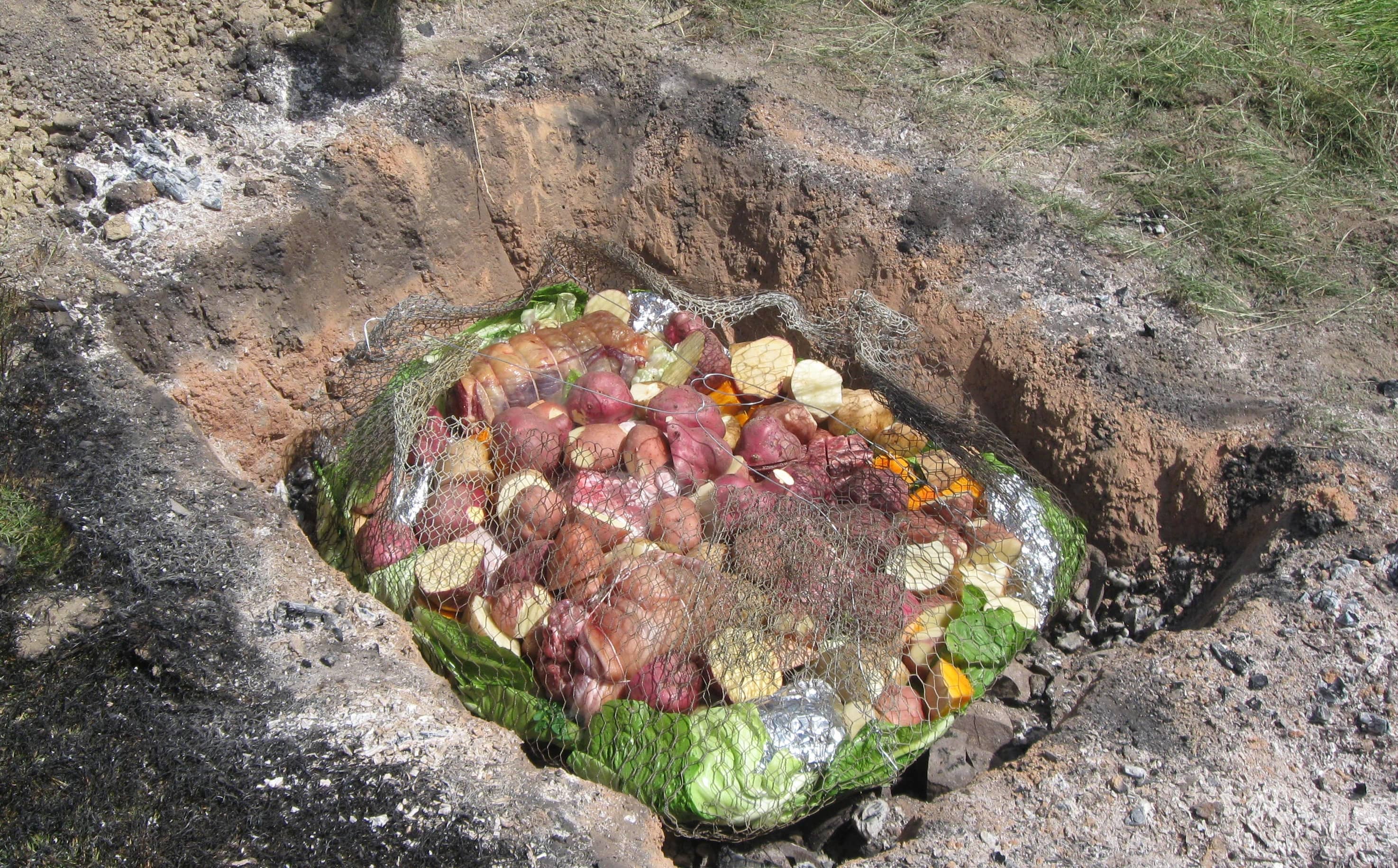 Vegetables and meat bundled up for a hāngī.